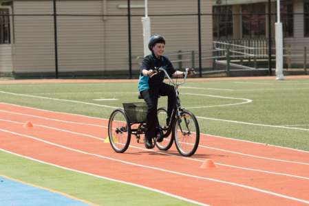 Student cycling outdoor fitness track