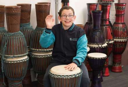 Student playing hand drum